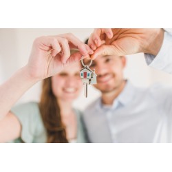 Un couple tient une clé maison